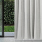 Pearl grey Dakota block out curtain beside a sliding glass door with a garden view