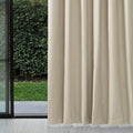 Almond Dakota block out curtain beside a sliding glass door with a garden view