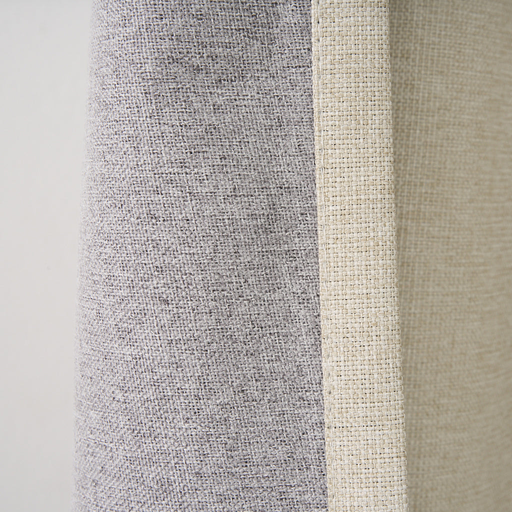 Close-up of the Dakota curtain's grey blockout lining against the almond face fabric and seam edge