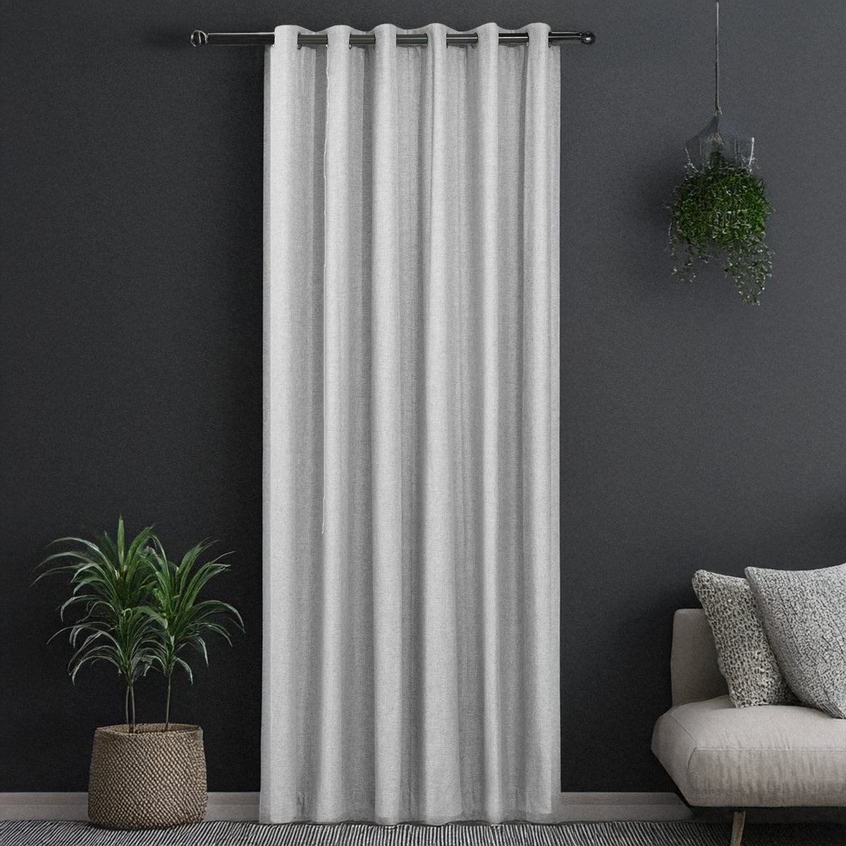 Creme grey Sinclair block out curtain styled in a room with a dark accent wall, potted plants and a sofa with cushions