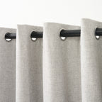 Close-up of several eyelet grommets along the top of the Sinclair curtain in creme grey