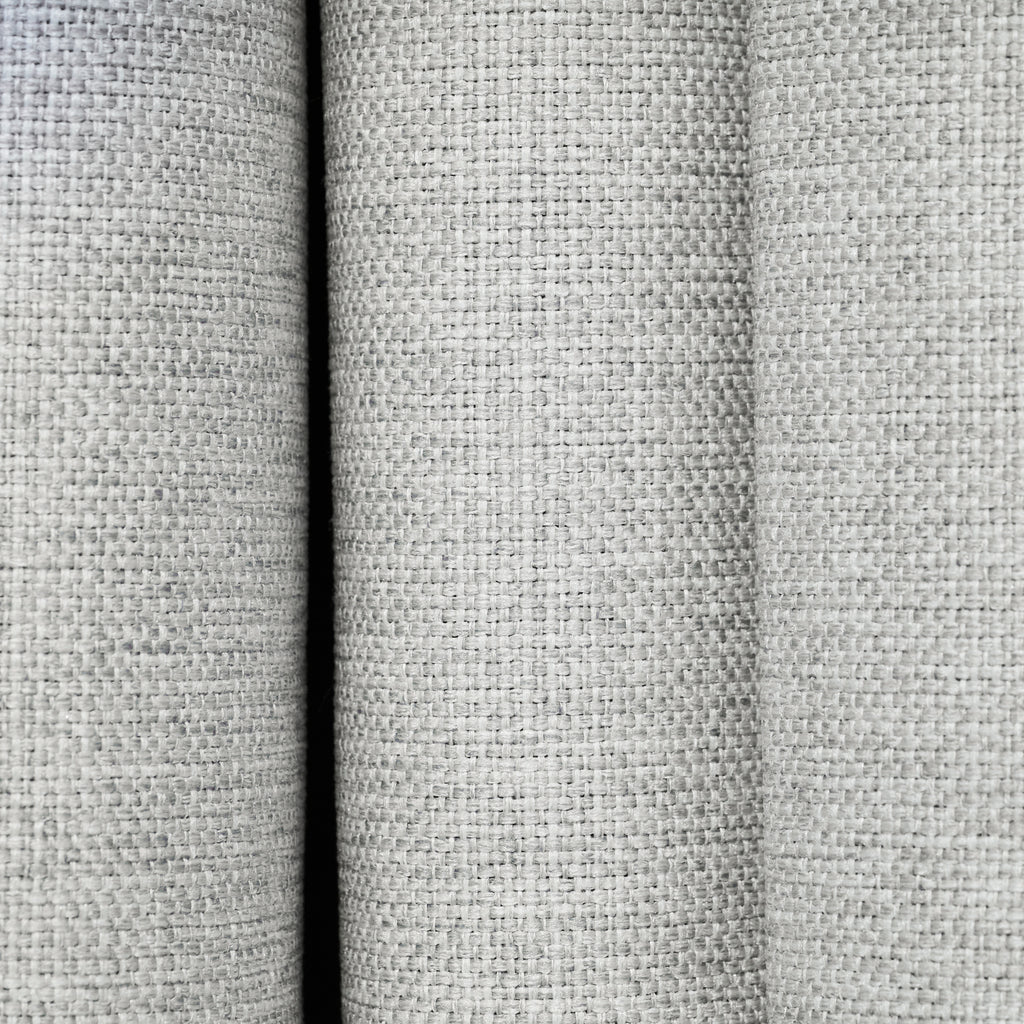 Close-up of the textured woven fabric on the Dakota block out curtain in pearl grey