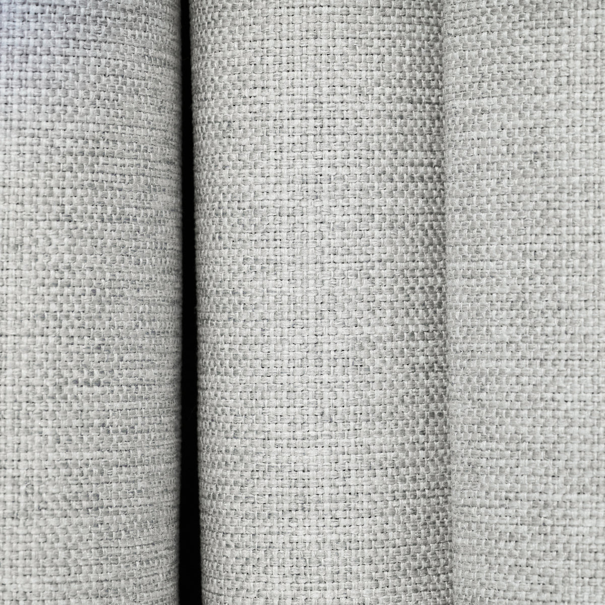 Close-up of the textured woven fabric on the Dakota block out curtain in pearl grey